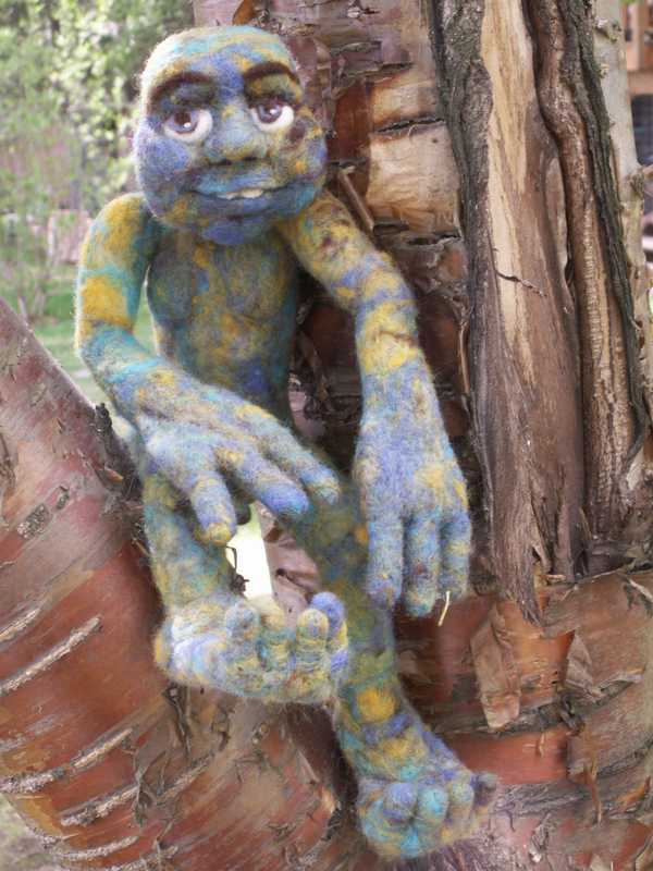 Doc Treeboat, a needle felted soft sculpture, hanging in the trees, happy to be alive!